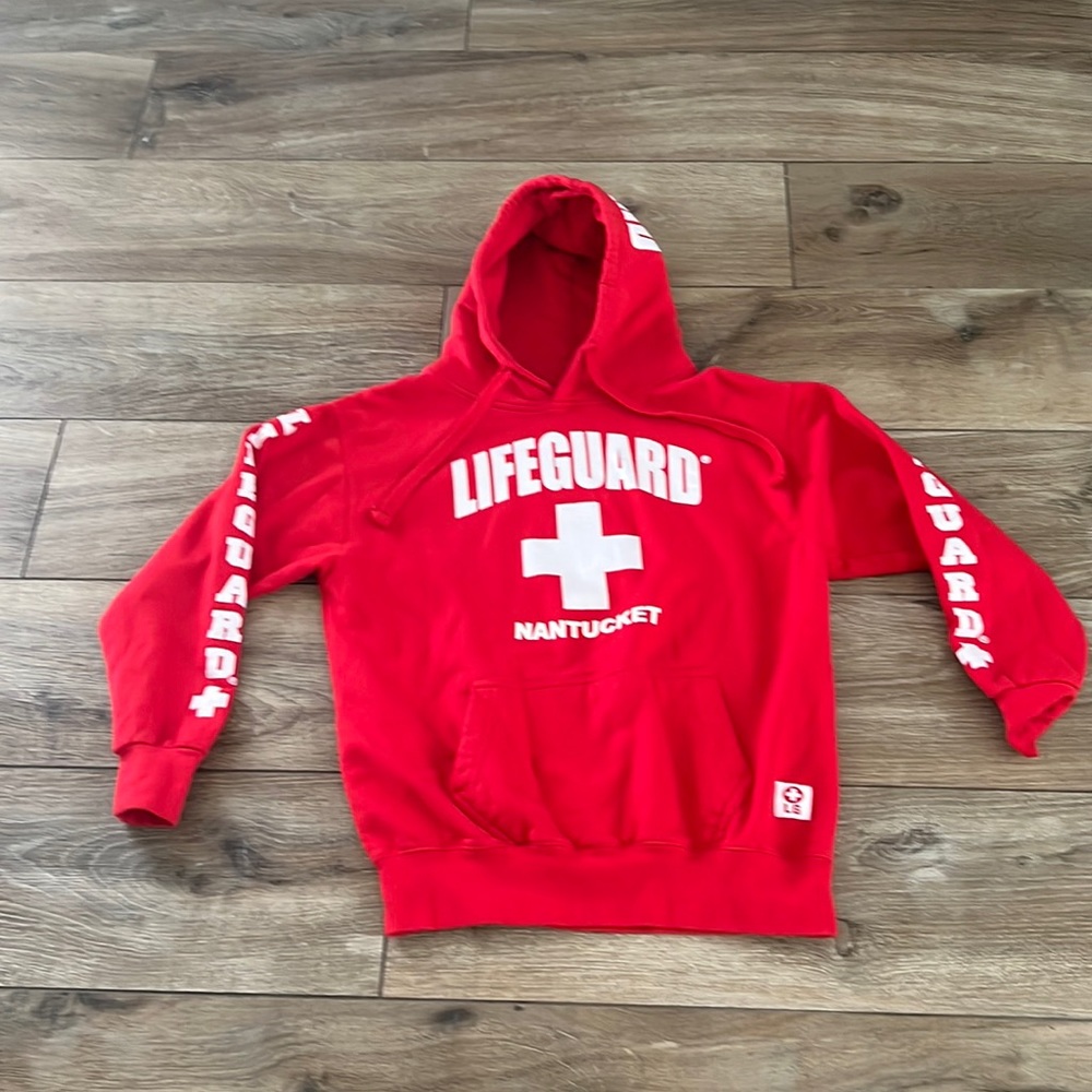 Red officially licensed lifeguard hoodie.  Pull over size small.